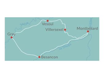 Carte montrant l'itinéraire cyclable en Franche-Comté avec les villes marquées : Montbéliard, Villersexel, Vesoul, Gray et Besançon reliées par ligne blanche.
