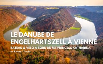 Vue aérienne du Danube formant une boucle en fer à cheval à travers des collines boisées en automne, avec des champs verts sur la presqu'île.