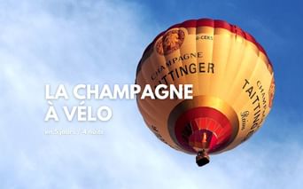 Montgolfière à l'effigie du champagne Taittinger, dans un ciel bleu