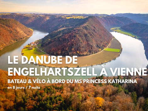 Vue aérienne du Danube formant une boucle en fer à cheval à travers des collines boisées en automne, avec des champs verts sur la presqu'île.