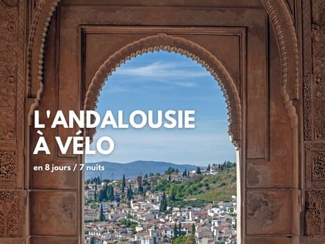 Vue sur un village blanc andalous depuis un arc maure