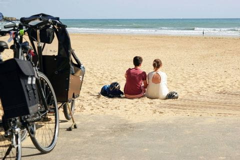 Deux cyclistes font une pause sur la plage du Veillon en Vendée