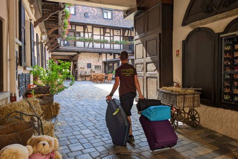 Notre collaborateur Julien transporte les valises de clients dans un hôtel d'Obernai en ALsace